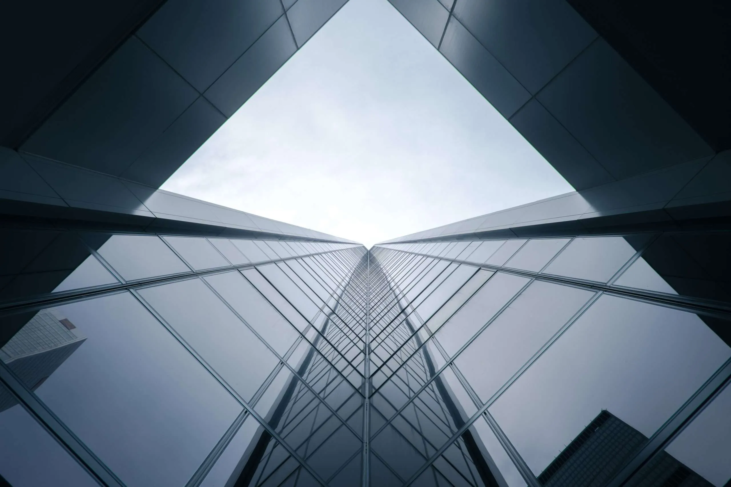 Upward view of a modern glass skyscraper